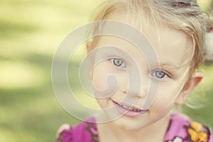 Charming little blue eyes girl with dreamy look