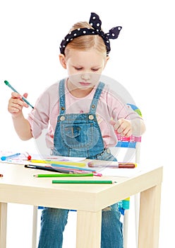 Charming little girl draws with markers while