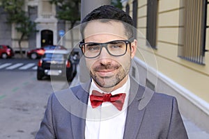 Charming man wearing tuxedo and elegant eyeglasses