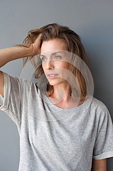 Charming mid adult woman posing with hand in hair