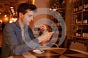 Charming millenial with tea in restaurant