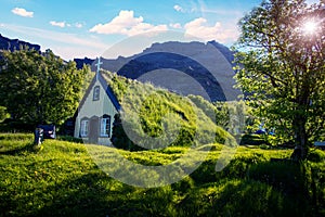 Charming mystical scene with turf roof church in old Iceland traditional style and mystical cemetery in Hof, Skaftafell,