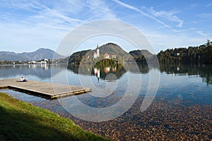 the charming natural scenery of Lake Bled with Alps at background and blue water