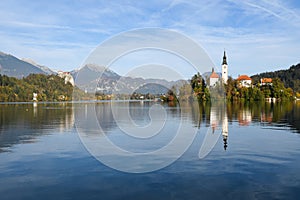 the charming natural scenery of Lake Bled with Alps at background and blue water