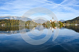 the charming natural scenery of Lake Bled with Alps at background and blue water