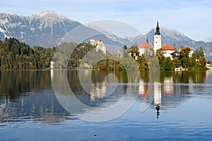 the charming natural scenery of Lake Bled with Alps at background and blue water