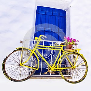 Charming old bike over the wall and window photo