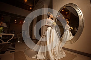 Charming portrait of young blonde bride in wedding dress