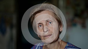 charming retiree woman, portrait in apartment with natural light, closeup of face with age changes