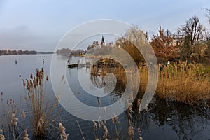River idyll in the city of Werder on the Havel. Warm light, trees and reeds. photo