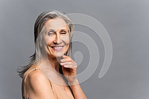 Charming smiling elderly woman isolated on gray-background