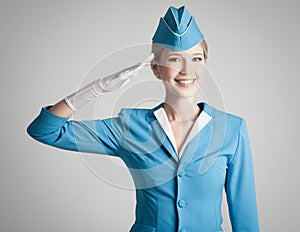 Charming Stewardess In Blue Uniform On Gray Background