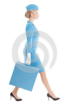 Charming Stewardess In Blue Uniform And Suitcase On White