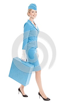 Charming Stewardess Dressed In Blue Uniform And Suitcase On White