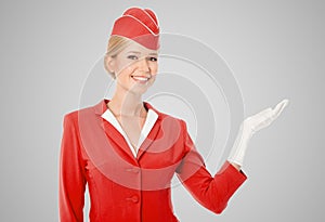 Charming Stewardess Dressed In Red Uniform Holding In Hand