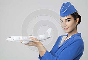 Charming Stewardess Holding Airplane In Hand.