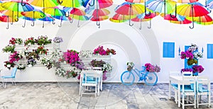 Charming street outdoor decoration with old bicycle , flowers and umbrellas. Bodrum, Turkey