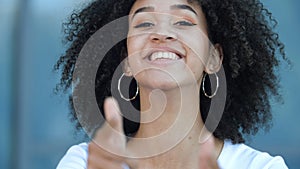 Charming stylish African American teen girl with afro hairstyle makes hand pistols hit goal, pretends to shoot gun from