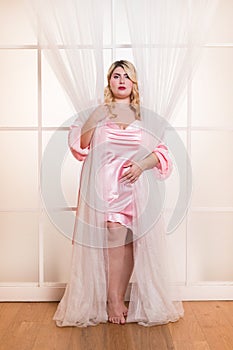 Charming stylish woman in petticoat standing in studio