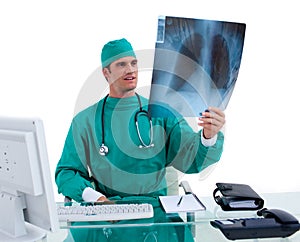 Charming surgeon looking at X-ray