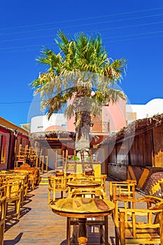 Charming traditional taverna outdoor seating Kamari Santorini Greece