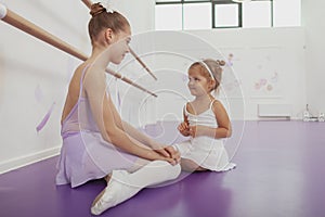 Charming two young ballerinas practicing at ballet class