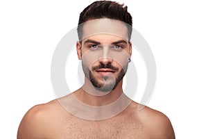 Charming undressed man with beard looking to camera