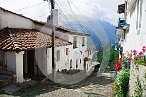 Charming village located outside Quito Ecuador with bridgestone road leading down to dome tower of spanish colonial