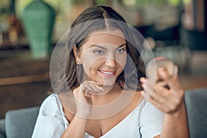 Charming woman admiring herself in mirror