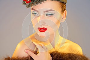 Charming woman with beautiful makeup in studio looking away