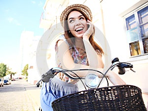 Charming woman on bike in city, during summer