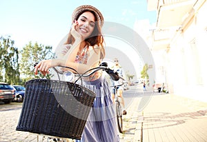 Charming woman on bike in city, during summer