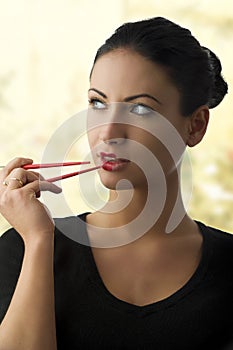 Charming woman with chopstick