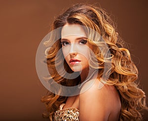 Charming woman with curly blond hair, attractive look and sensual lips, fashion model