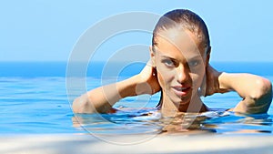 Charming woman in exotic swimming pool