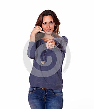 Charming woman gesturing call me sign