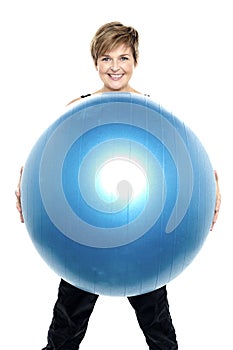 Charming woman holding big blue fitness ball