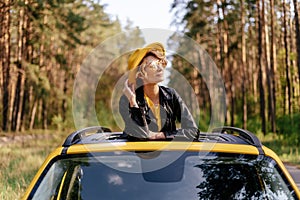 Charming Woman Leaning at Yellow Auto Sunroof