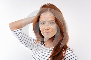 Charming woman posing with her hand on back of head