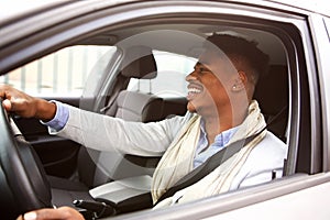 Charming young african american man driving car in the city