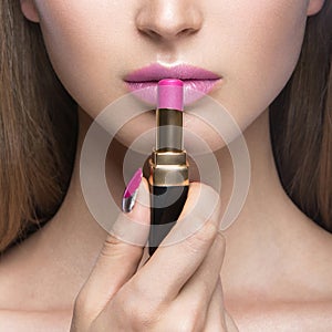 Charming young babe with lipstick and light makeup.