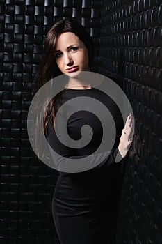 Charming young brunette posing in the studio