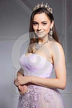 Charming young brunette posing in the studio