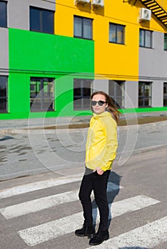 A charming young business woman crossing street