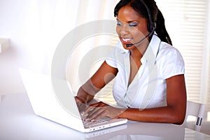 Charming young receptionist working on laptop