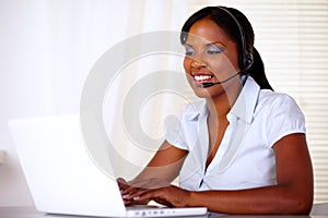 Charming young secretary working on laptop