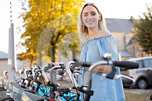 charming young traveler renting bicycle outdoors