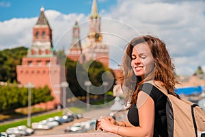 A charming young woman with a background on the Kremlin in Moscow