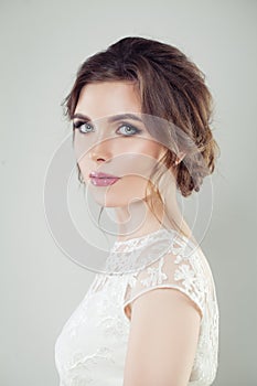 Charming young woman. Beautiful bride with makeup and bridal hairstyle