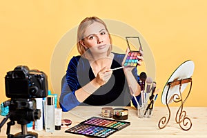 Charming young woman blogger working on content for personal beauty blog